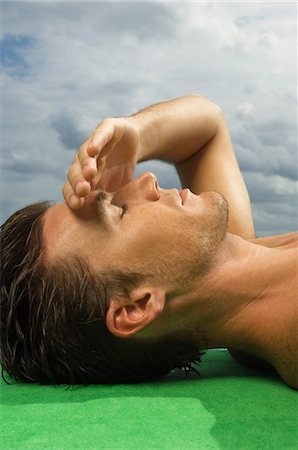 simsearch:6108-05863886,k - Close-up of a man sunbathing Stock Photo - Premium Royalty-Free, Code: 6108-05863871