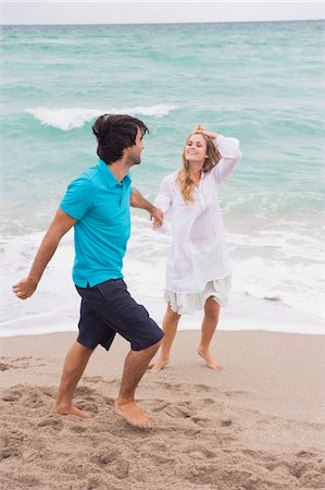 simsearch:6108-05866106,k - Couple walking with holding hands on the beach Stock Photo - Premium Royalty-Free, Code: 6108-05863978