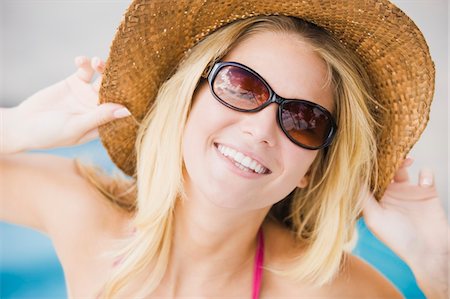 fashion photography swimming pool - Close-up of a woman smiling Stock Photo - Premium Royalty-Free, Code: 6108-05863924
