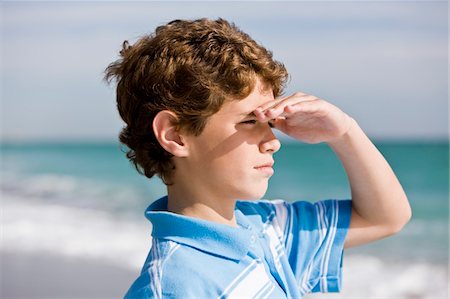 Close-up of a boy looking out to sea Stock Photo - Premium Royalty-Free, Code: 6108-05864092