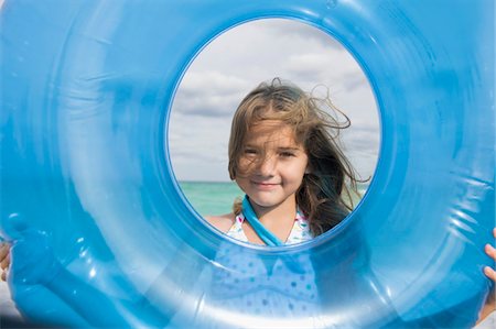 sky circle - Girl looking through an inflatable ring Stock Photo - Premium Royalty-Free, Code: 6108-05864159