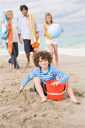 people carrying water buckets - Family enjoying vacations on the beach Stock Photo - Premium Royalty-Free, Code: 6108-05864160
