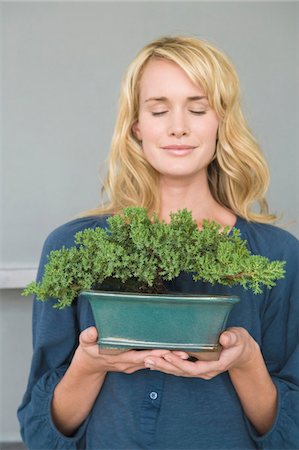 Woman holding a potted plant Stock Photo - Premium Royalty-Free, Code: 6108-05864245