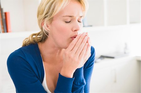 Close-up of a woman coughing Stock Photo - Premium Royalty-Free, Code: 6108-05864259
