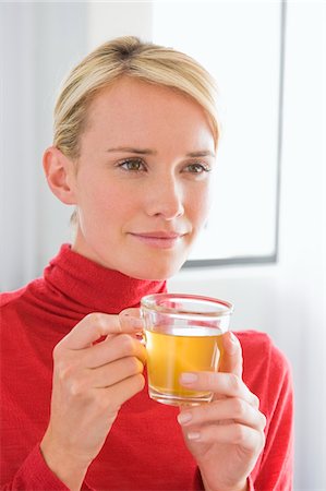 Close-up of a woman holding a cup of tea Stock Photo - Premium Royalty-Free, Code: 6108-05864278