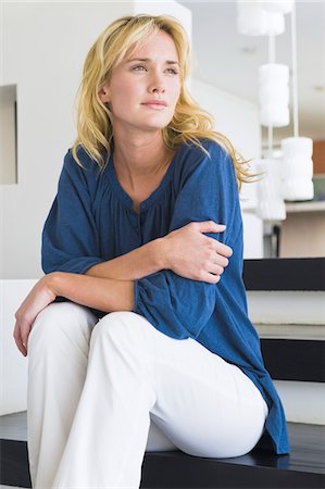 Woman sitting on steps and thinking Stock Photo - Premium Royalty-Free, Code: 6108-05864289