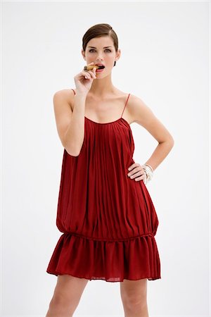 fashion red dress studio shot - Fashion model smoking a cigar Stock Photo - Premium Royalty-Free, Code: 6108-05864357