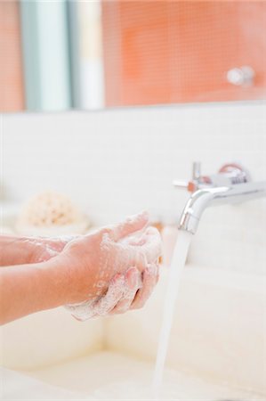 simsearch:6108-05856072,k - Woman washing hands in the bathroom Fotografie stock - Premium Royalty-Free, Codice: 6108-05864443