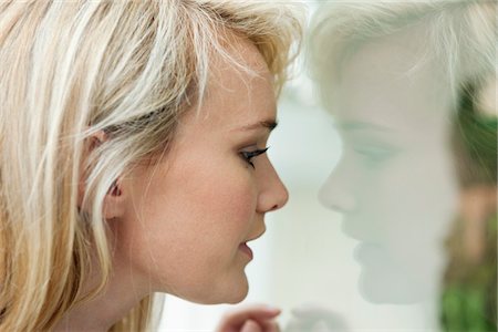 Woman window shopping in a boutique Stock Photo - Premium Royalty-Free, Code: 6108-05864578