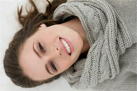sweaters turtleneck - Woman lying on the floor and smiling Stock Photo - Premium Royalty-Free, Code: 6108-05864640