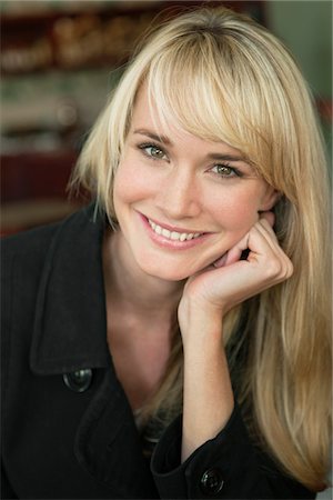 fringe hair - Woman sitting in a cafe and smiling Stock Photo - Premium Royalty-Free, Code: 6108-05864684