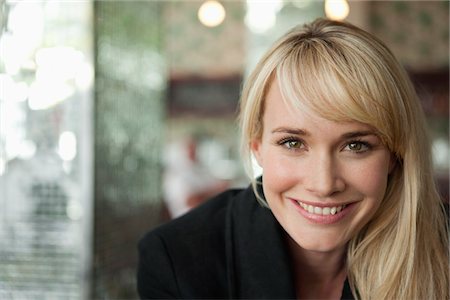 Portrait of a woman smiling in a cafe Stock Photo - Premium Royalty-Free, Code: 6108-05864633