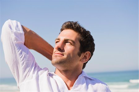 pic of a man dreaming - Man looking up on the beach Stock Photo - Premium Royalty-Free, Code: 6108-05864899