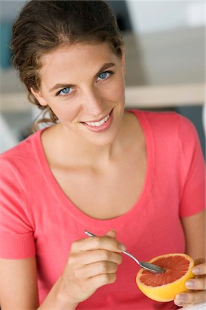Portrait of a woman eating grapefruit Foto de stock - Royalty Free Premium, Número: 6108-05864956
