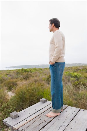 simsearch:6108-05874310,k - Man standing on a boardwalk and thinking Stock Photo - Premium Royalty-Free, Code: 6108-05865041