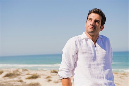 pic of a lonely person standing alone - Man looking up on the beach Stock Photo - Premium Royalty-Free, Code: 6108-05865039