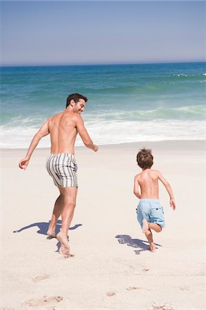 dad not mom child back - Man running with his son on the beach Stock Photo - Premium Royalty-Free, Code: 6108-05865161