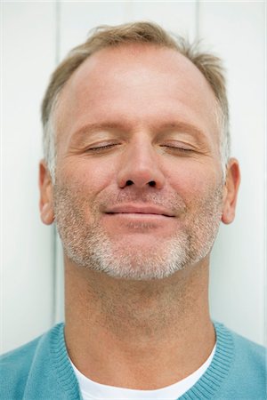 smiling man face - Close-up of a man day dreaming Stock Photo - Premium Royalty-Free, Code: 6108-05865313