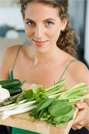 simsearch:6108-05865420,k - Woman holding vegetables in the kitchen Stock Photo - Premium Royalty-Free, Code: 6108-05865418