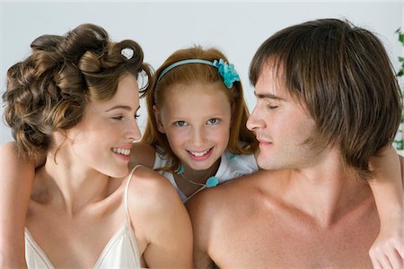 Close-up of a couple smiling with their daughter Stock Photo - Premium Royalty-Free, Code: 6108-05865542