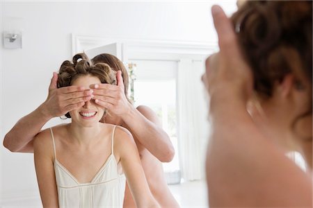 simsearch:6108-05865507,k - Man covering woman's eyes from behind Stock Photo - Premium Royalty-Free, Code: 6108-05865550