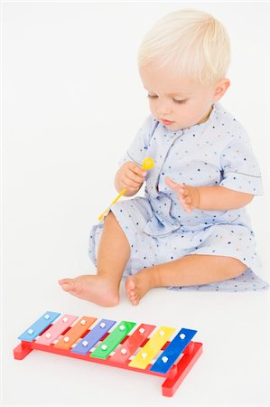 Baby boy playing with a xylophone Stock Photo - Premium Royalty-Free, Code: 6108-05865654