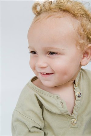 fossetta - Close-up of a baby boy smiling Fotografie stock - Premium Royalty-Free, Codice: 6108-05865673