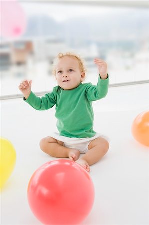 Baby boy playing with balloons Stock Photo - Premium Royalty-Free, Code: 6108-05865674