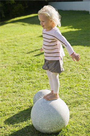 simsearch:6108-05865608,k - Girl standing on a round stone Stock Photo - Premium Royalty-Free, Code: 6108-05865621