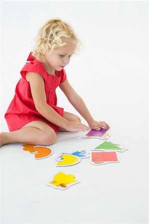 simsearch:6108-05873482,k - Girl solving a jigsaw puzzle Stock Photo - Premium Royalty-Free, Code: 6108-05865622