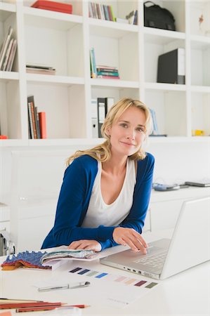 Businesswoman choosing color swatches Stock Photo - Premium Royalty-Free, Code: 6108-05865783