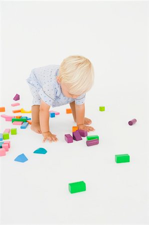 Baby boy playing with blocks Stock Photo - Premium Royalty-Free, Code: 6108-05865707