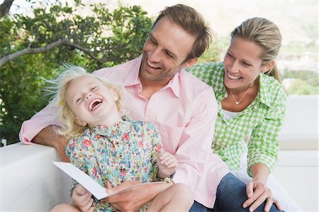Girl smiling with her parents Stock Photo - Premium Royalty-Free, Code: 6108-05865803