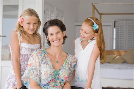 red hair daughter with mom - Woman smiling with her two daughters Stock Photo - Premium Royalty-Free, Code: 6108-05865834