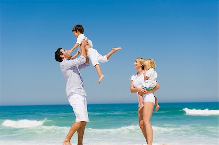 father beach carry - Family enjoying vacations on the beach Stock Photo - Premium Royalty-Free, Code: 6108-05865993