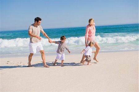 simsearch:6108-05865807,k - Family enjoying vacations on the beach Stock Photo - Premium Royalty-Free, Code: 6108-05866036