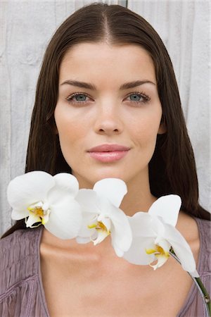 Portrait of a woman holding flowers Stock Photo - Premium Royalty-Free, Code: 6108-05866154