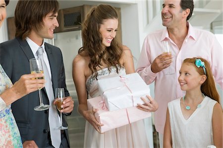 people looking up amazed - Bride receiving gifts from guests in a party Stock Photo - Premium Royalty-Free, Code: 6108-05866244