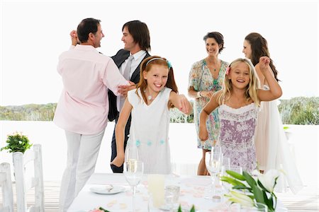 Newlywed couple with guests in a wedding party Stock Photo - Premium Royalty-Free, Code: 6108-05866263