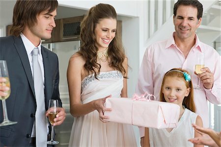 Bride receiving a gift from a guest in a party Stock Photo - Premium Royalty-Free, Code: 6108-05866276
