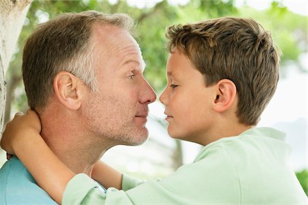 rubbing man - Man and his son rubbing noses Stock Photo - Premium Royalty-Free, Code: 6108-05866366