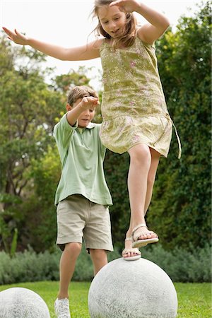 rock and shoe - Boy and a girl playing in a garden Stock Photo - Premium Royalty-Free, Code: 6108-05866393