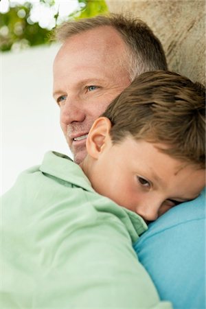 sad young boy - Boy hugging his father Stock Photo - Premium Royalty-Free, Code: 6108-05866455