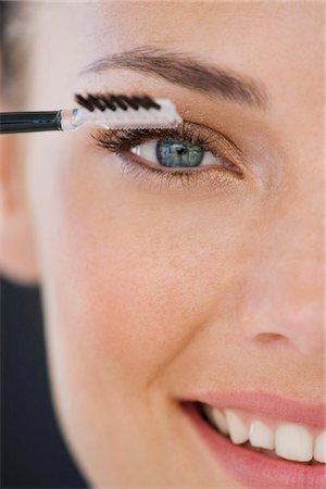 simsearch:6108-05861268,k - Portrait of a woman applying eye make-up Stock Photo - Premium Royalty-Free, Code: 6108-05866500