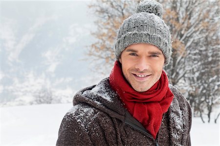 portrait snow - Young man in winter clothes smiling at camera Stock Photo - Premium Royalty-Free, Code: 6108-05866846