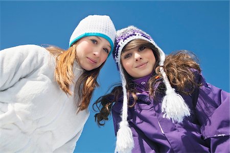 Two teenage girls in winter clothes, smiling at camera Stock Photo - Premium Royalty-Free, Code: 6108-05866954