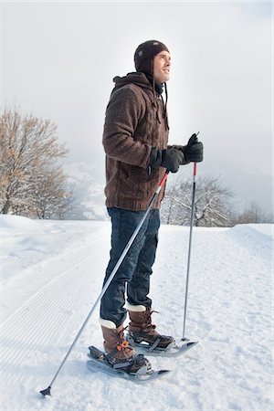 pictures of man snowshoeing - Young man wearing snowshoes Stock Photo - Premium Royalty-Free, Code: 6108-05867036