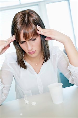 stress woman computer - Businesswoman suffering from a headache Stock Photo - Premium Royalty-Free, Code: 6108-05867262