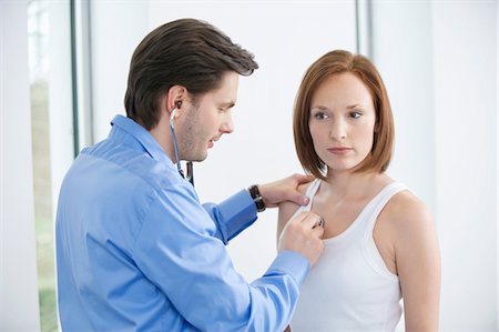 Doctor examining a patient with a stethoscope Stock Photo - Premium Royalty-Free, Code: 6108-05867274