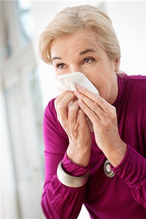 Close-up of a woman suffering from cold Stock Photo - Premium Royalty-Free, Code: 6108-05867289